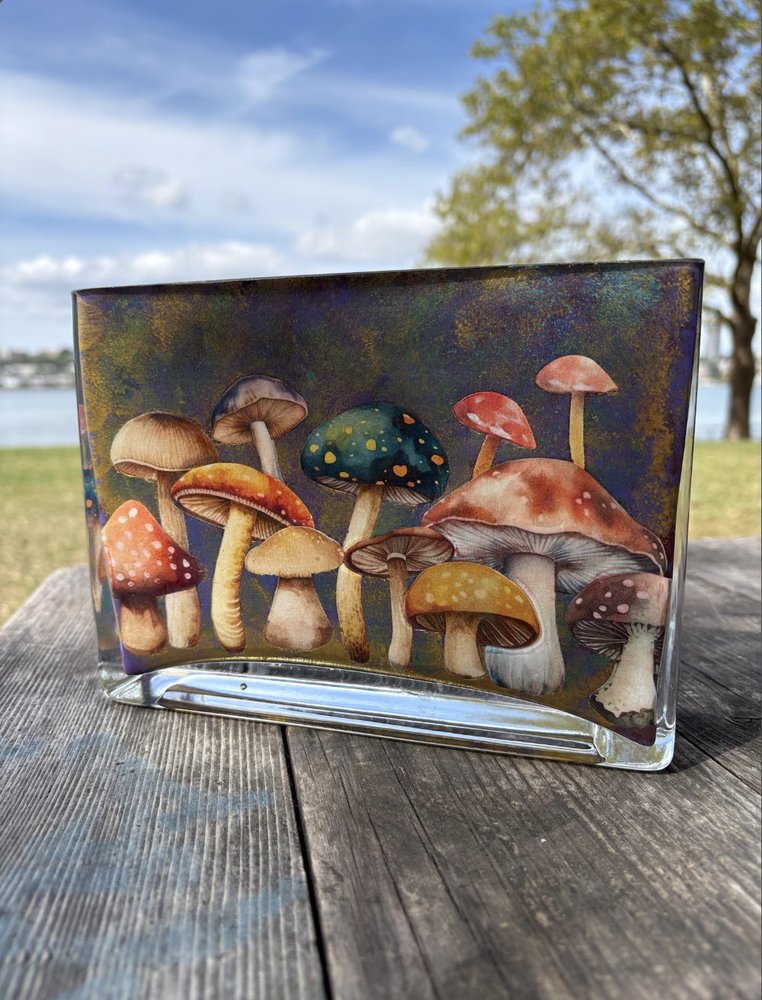 Glass vase decoupaged with an illustrated cluster of colorful mushrooms